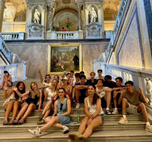 international-students-sitting-on-the-steps-of-natural-history-museum-in-vienna